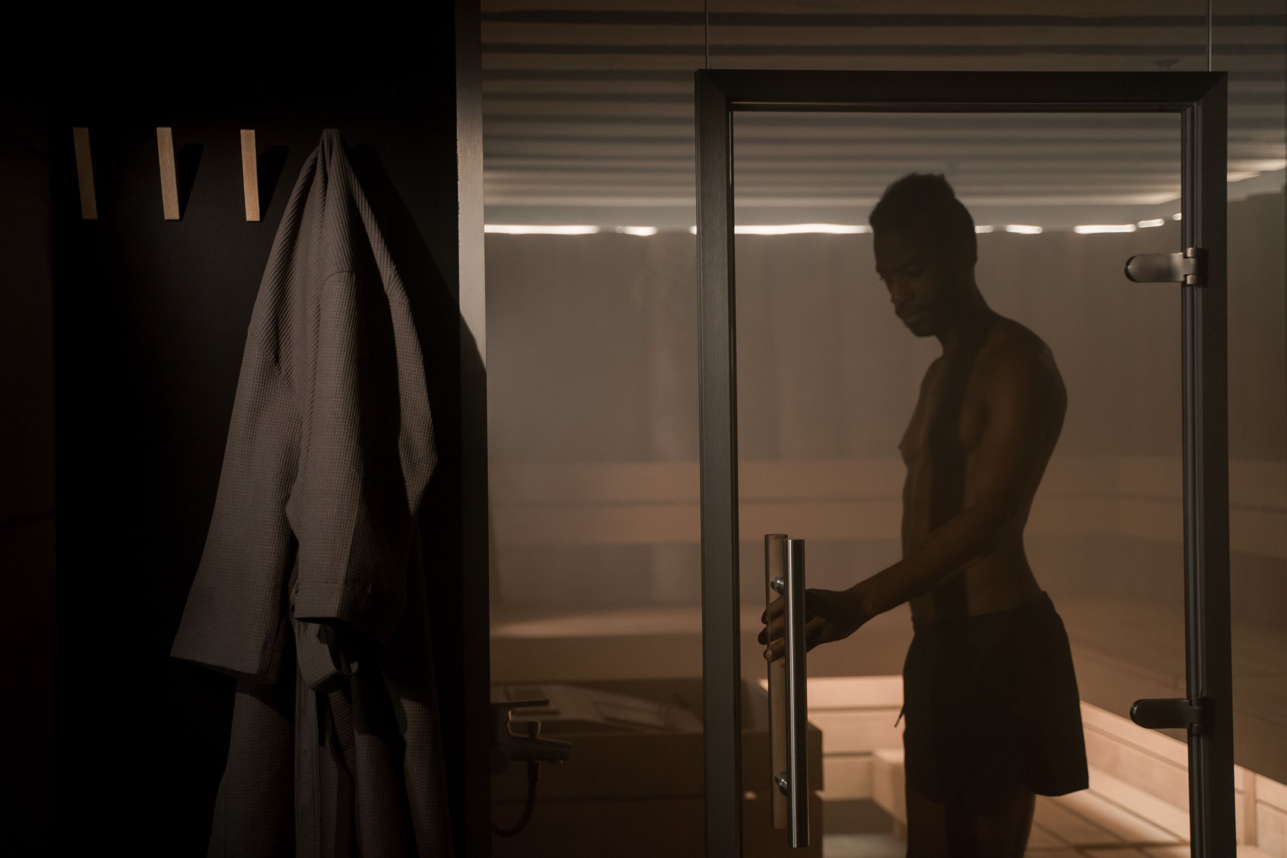 Person entering a traditional sauna before a heat exposure session
