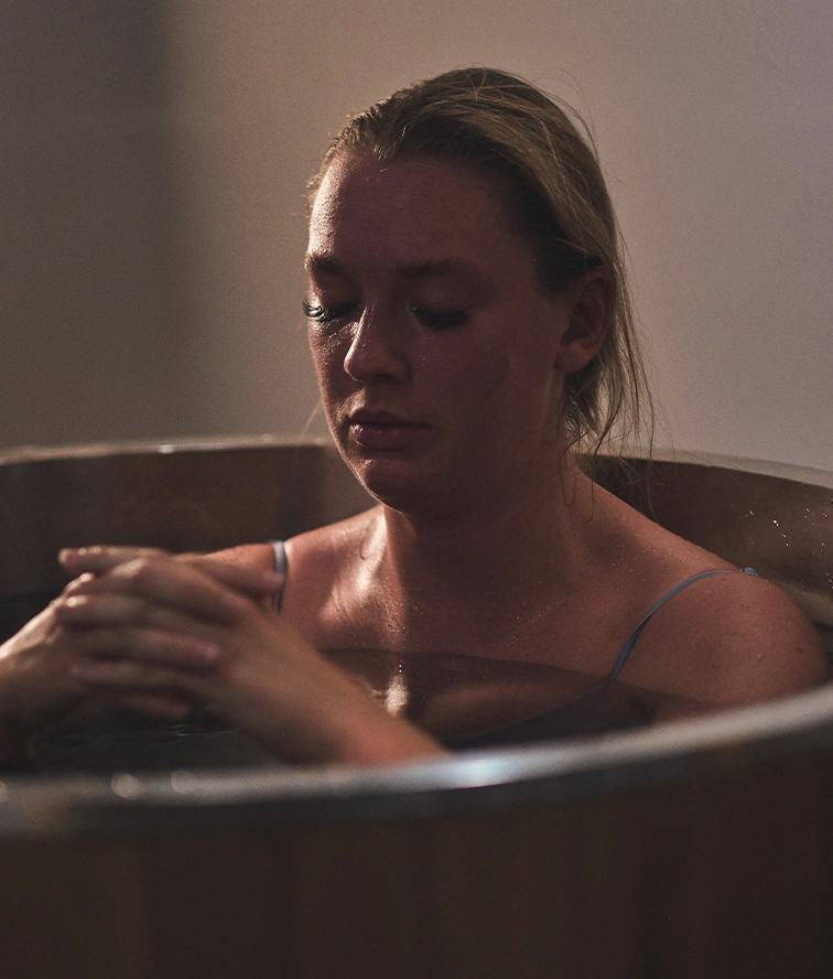 Close-up of a participant embracing the warmth and meditative atmosphere.